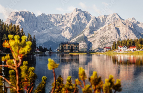 Wonderful Autumn Landscape. Great view on Misurina Lake with the Punta Sorapis mountain of Dolomites in the background, in sunny day. National Park Tre Cime di Lavaredo, Auronzo, South Tyrol, Italy,