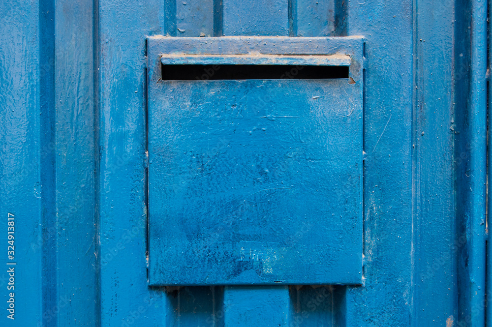 mailbox on a blue metallic door
