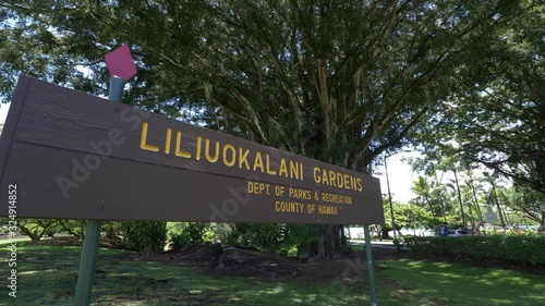 Tilt up, sign for Liliuokalani Gardens in Hawaii