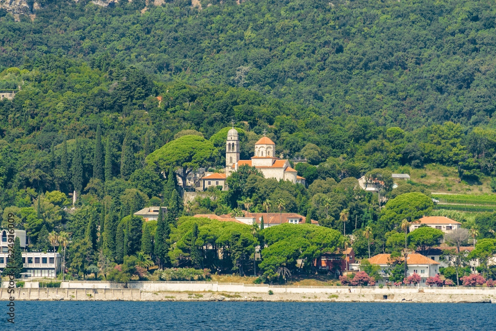 Sunny view of the Herceg Novi from the sea on the background of mountains, Montenegro.