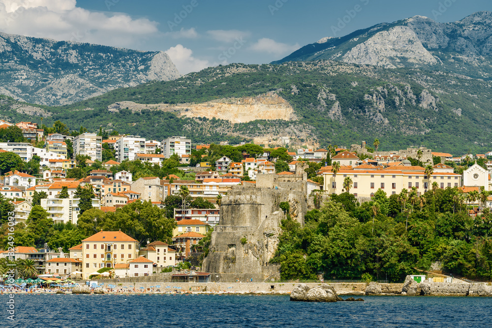 Sunny view of the Herceg Novi from the sea on the background of mountains, Montenegro.