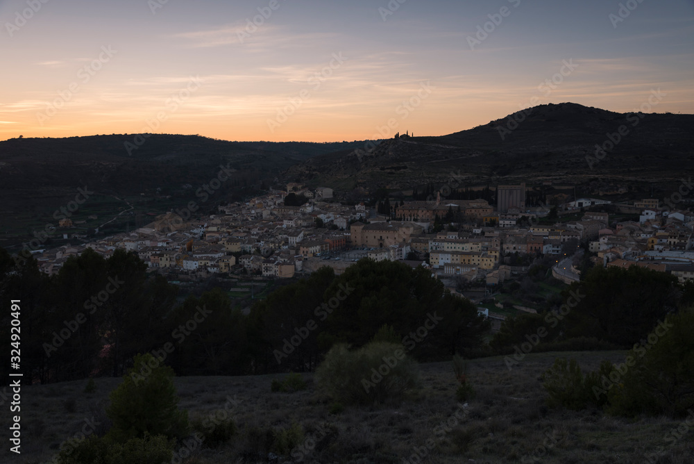 A top view of the medieval village of Pastrana surrounded by mountains at sunset, Guadalajara, Spain