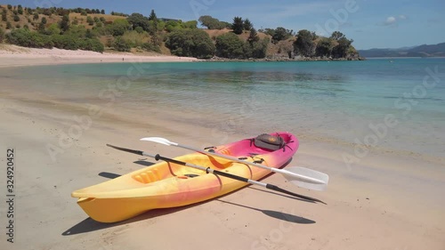 A kayak pulled up on the shoreline of a tropical beach, New Zealand photo