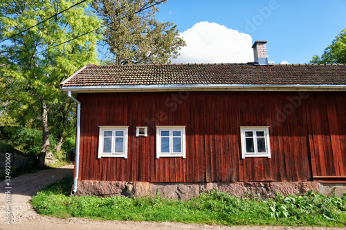 View of traditional red wooden cottage in Turku, Finland. This rural area has been inhabited since the 7th century. © Finmiki