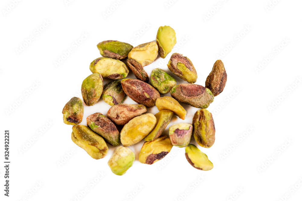 A bunch of uncooked raw pistachios. Isolated on a white background. Close-up. A bunch of uncooked raw pistachios. Isolated on a white background. Close-up.
