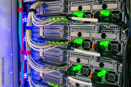 Many network cables are connected to the data center equipment. Hosting platform for modern Internet resources. Rack with server data storage equipment.