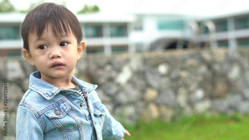 A boy in a denim jacket with his hands pointed A boy in a denim jacket with his hands pointed