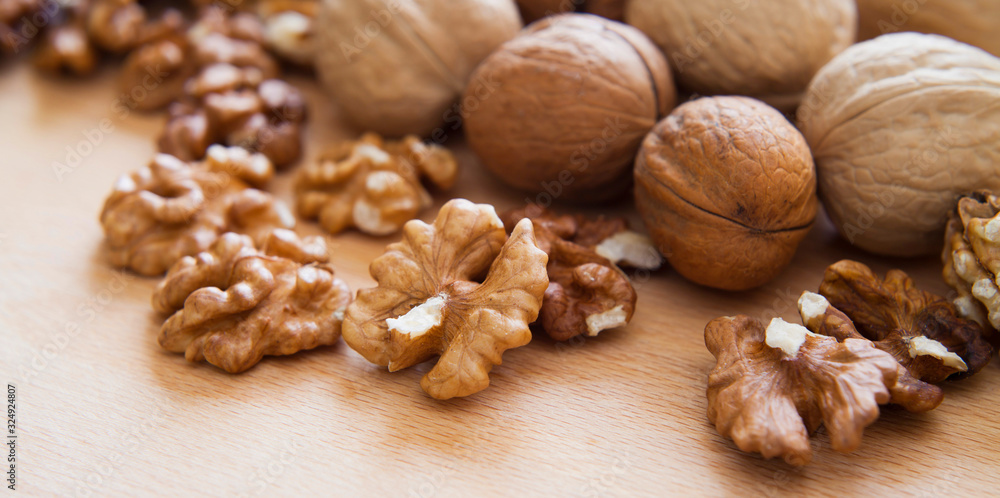 Fresh healthy walnuts nuts seeds on the wooden rustic board. Close up of the the open halves. Fresh healthy walnuts nuts seeds on the wooden rustic board. Close up of the the open halves.