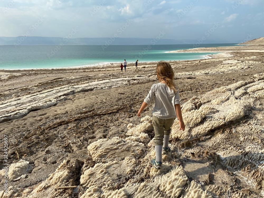 Little girl on the Death Sea beach in Jordan Little girl on the Death Sea beach in Jordan