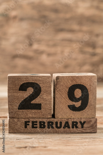 cube calendar for february on wooden background with copy space