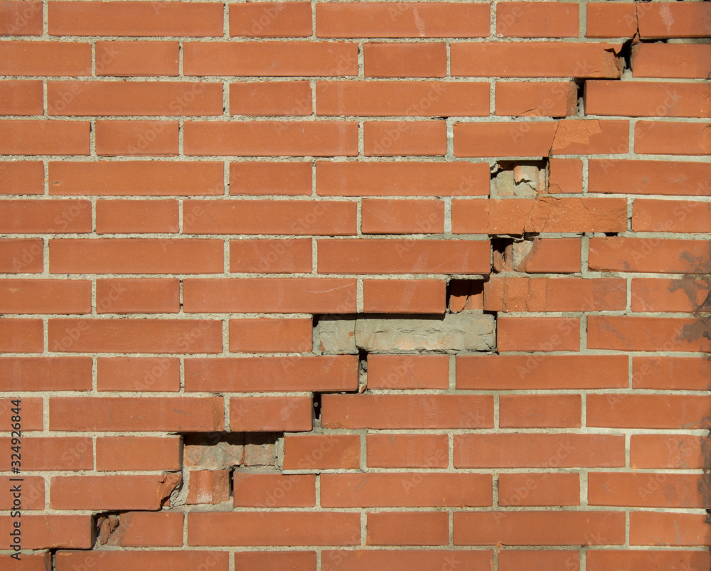 Obraz premium Pared de ladrillo agrietada