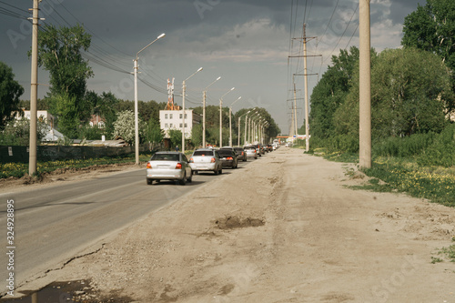 cars are in traffic on a bad road