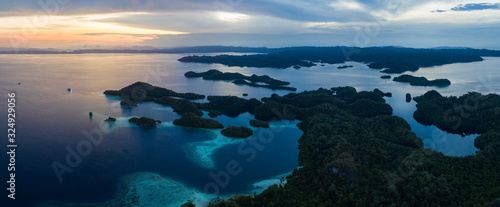 A serene dawn breaks over the limestone islands in Raja Ampat, Indonesia. This amazing region is famous for its high marine biodiversity and is a popular destination for divers and snorkelers.