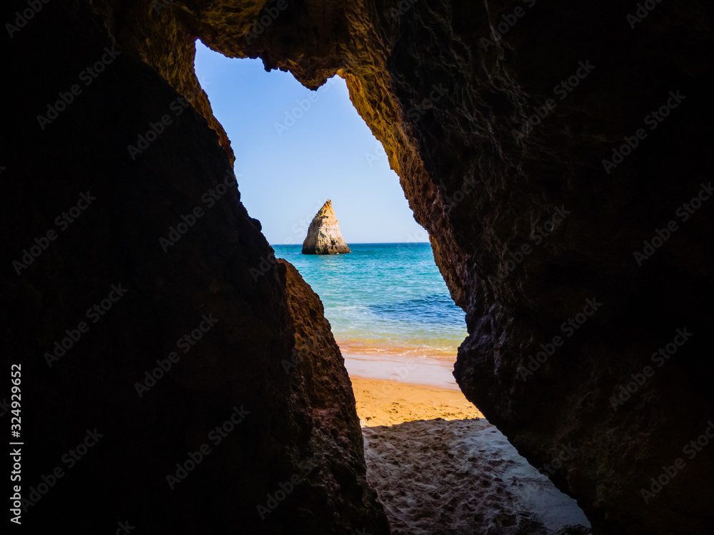Algarve beach, Portugal, look at the sea through the grottoes of the rocks