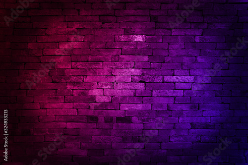 Neon light on brick walls that are not plastered background and texture. Lighting effect red and blue neon background of empty brick basement wall.