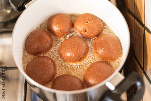 Homemade doughnut frying in the pot