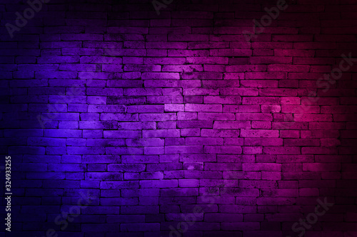 Neon light on brick walls that are not plastered background and texture. Lighting effect red and blue neon background of empty brick basement wall.