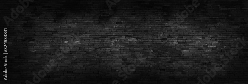 Panorama black brick walls that are not plastered background and texture. The texture of the brick is black. Background of empty brick basement wall.