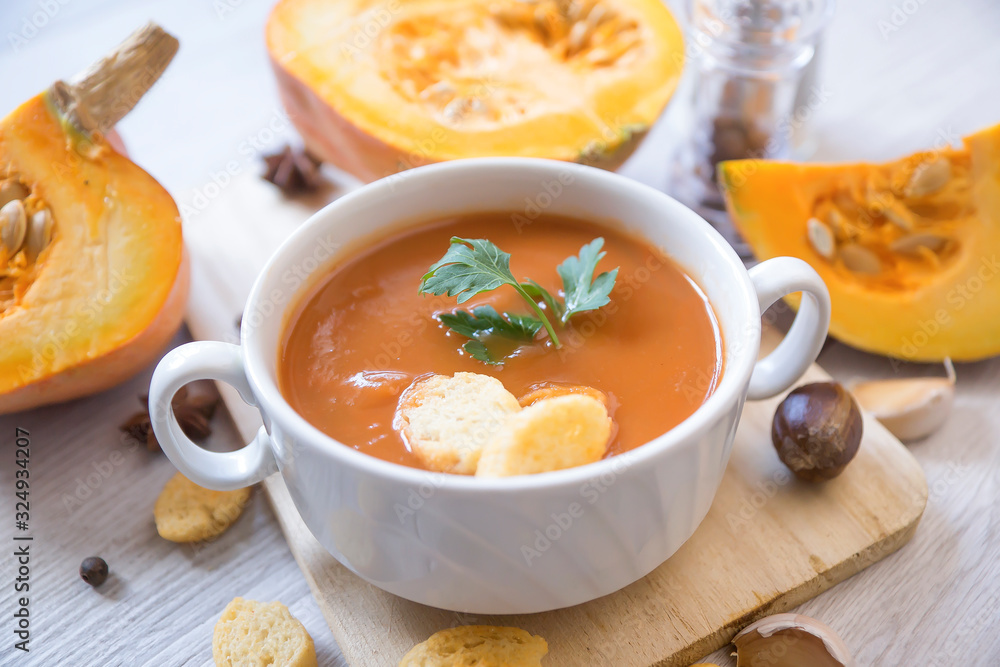 umpkin puree soup, pumpkin, spices on a wooden white background. umpkin puree soup, pumpkin, spices on a wooden white background.
