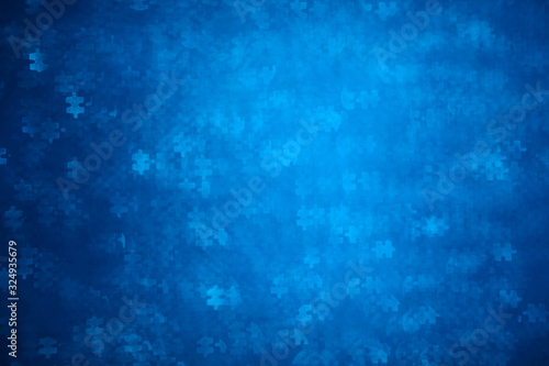 Blue Puzzle shape bokeh. Defocused background for autism awareness day. Real photo. Light blue
