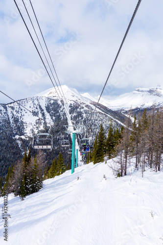 Skiers on Chairlift Up a Ski Slope in the Canadian Rockies