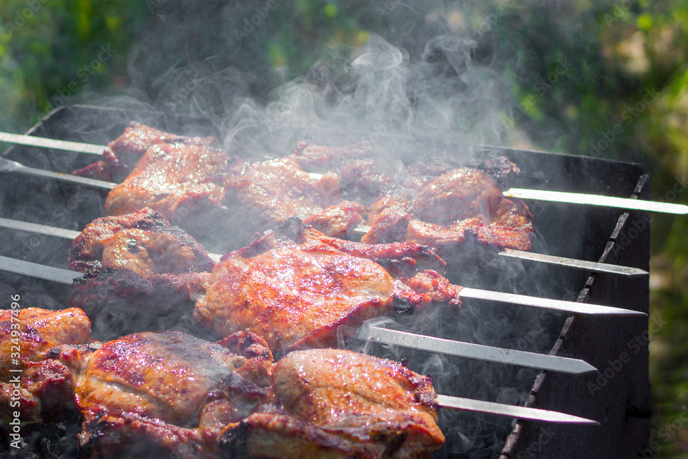 meat is fried on skewers on charcoal meat is fried on skewers on charcoal