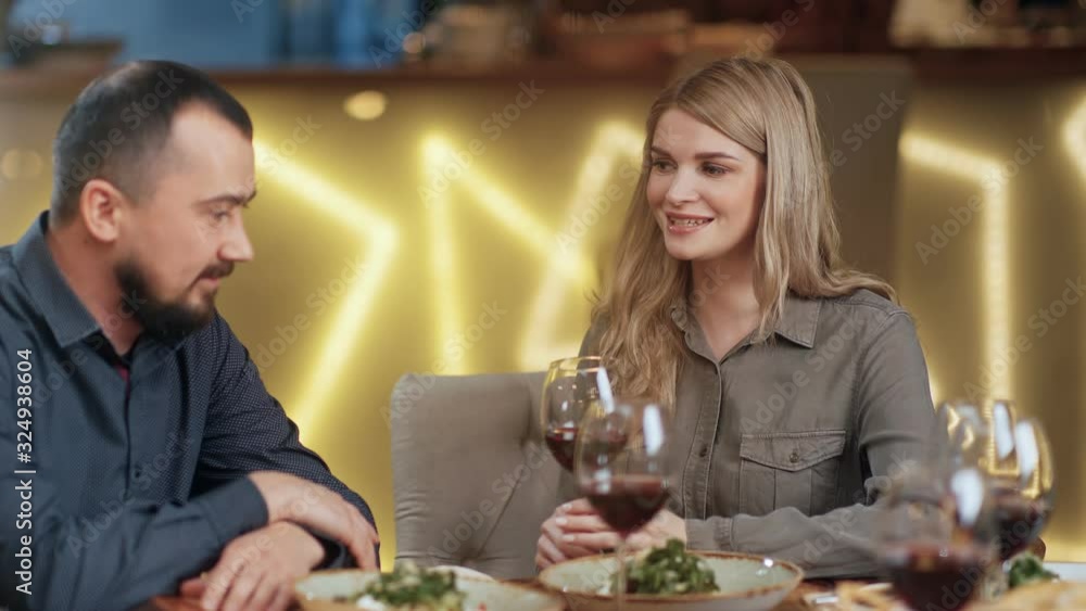 Laugh girl and guy friendly conversation drinking wine at cafe. Close up shot on 4k RED camera Laugh girl and guy friendly conversation drinking wine at cafe. Close up shot on 4k RED camera