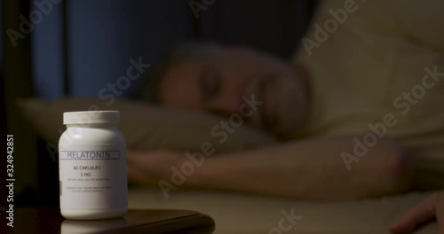 A mature man who used Melatonin to get to sleep enjoys a restful night.