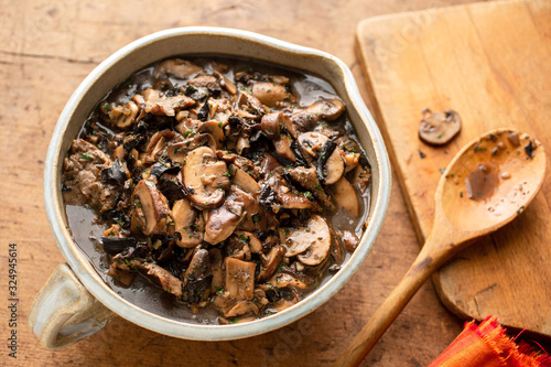 Close up of mushroom ragout served in bowl on table