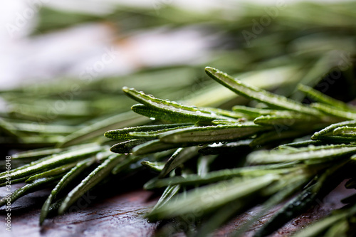 Selective focus of rosemary on wooden surface