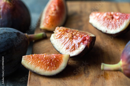 Selective focus of sliced fig on wooden board photo