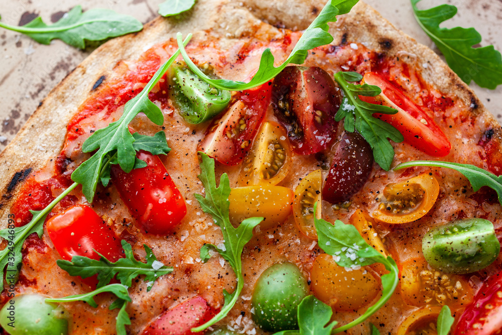 Directly above view of pizza with cherry tomatoes and arugula Directly above view of pizza with cherry tomatoes and arugula