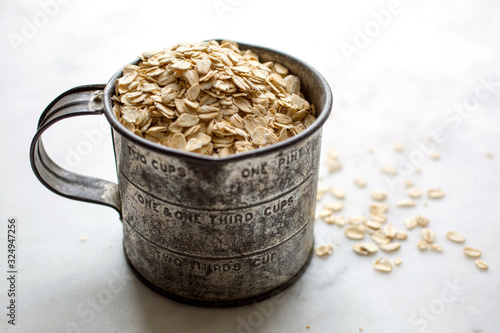 Cup filled with rolled oats photo