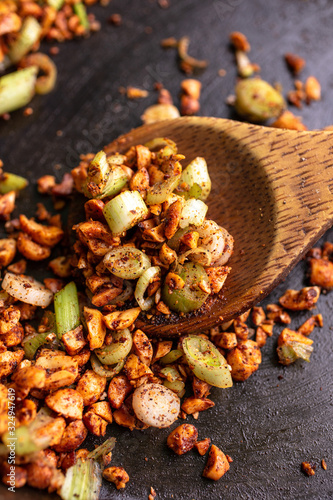 Selective focus of chopped peanuts on wooden surface