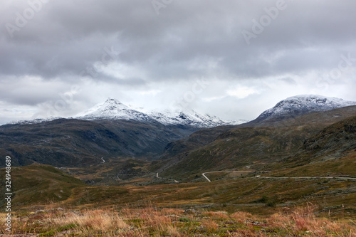 Mountain snow, grass rocks peaks Norway landscape