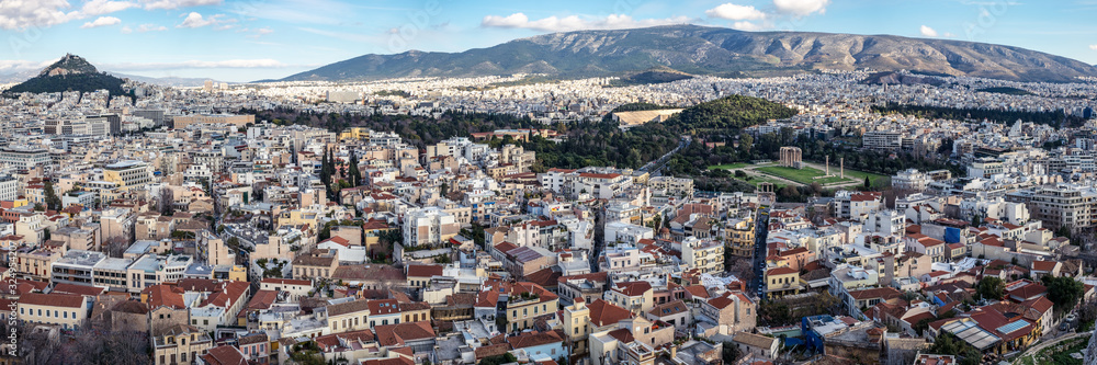 Panoramic view of the Athens city with  Lykavittos hill, The Greek Parliament in the center and to the far right the Temple of Olympian Zeus,