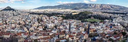Panoramic view of the Athens city with Lykavittos hill, The Greek Parliament in the center and to the far right the Temple of Olympian Zeus,