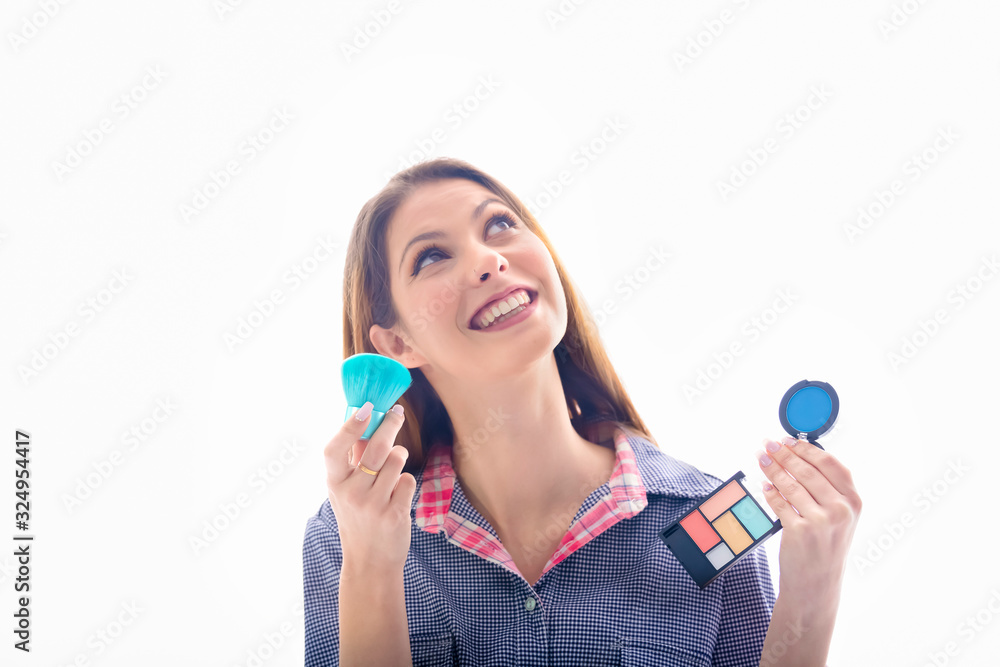 Beautiful woman holding eyeshadow palette and brush Beautiful woman holding eyeshadow palette and brush