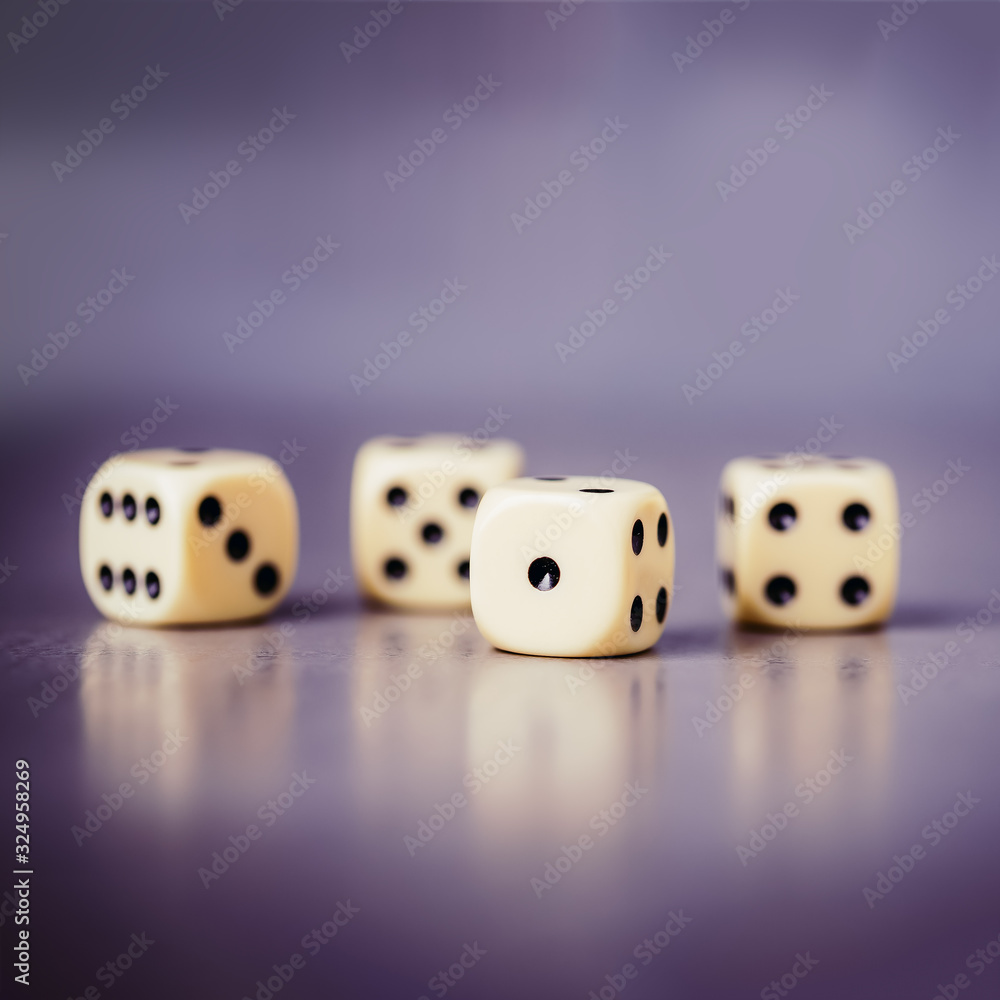 Four dices on a gray violet background, copy space Four dices on a gray violet background, copy space