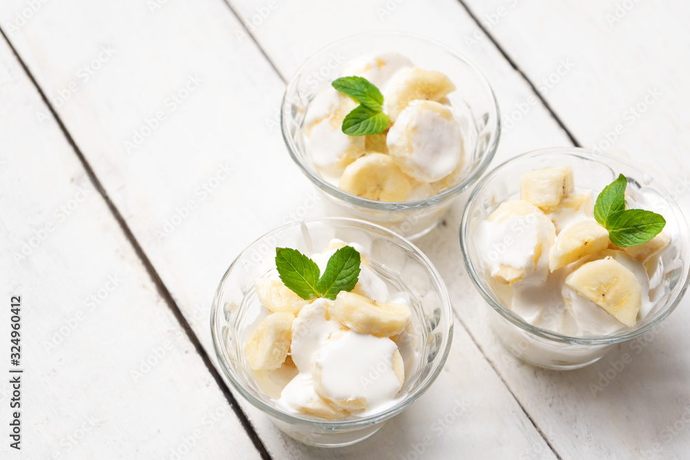 Banana with sour cream on white background Banana with sour cream on white background