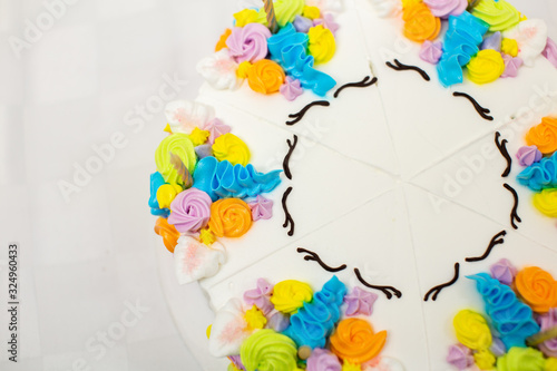 Unicorn themed birthday cake on white background