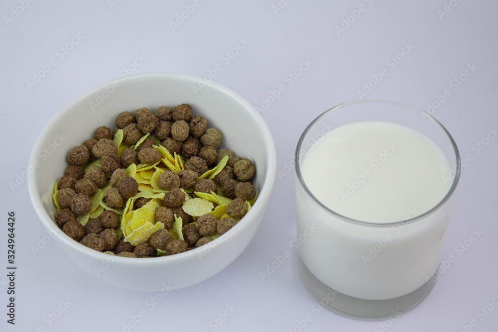 Chocolate cereal and corn flakes with glass of milk Chocolate cereal and corn flakes with glass of milk