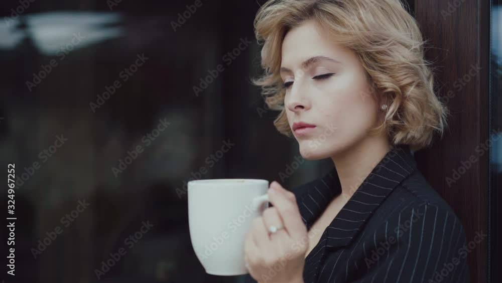 Portrait of beautiful lady thinks and drinks a cup of tea at house. 4K Portrait of beautiful lady thinks and drinks a cup of tea at house. 4K