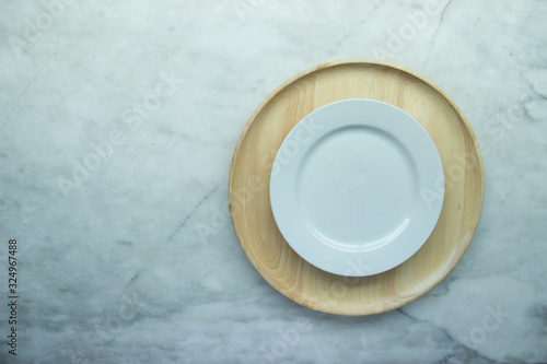 Top view, Closed up empty blank dishware on wooden tray and place on grey granite table.
