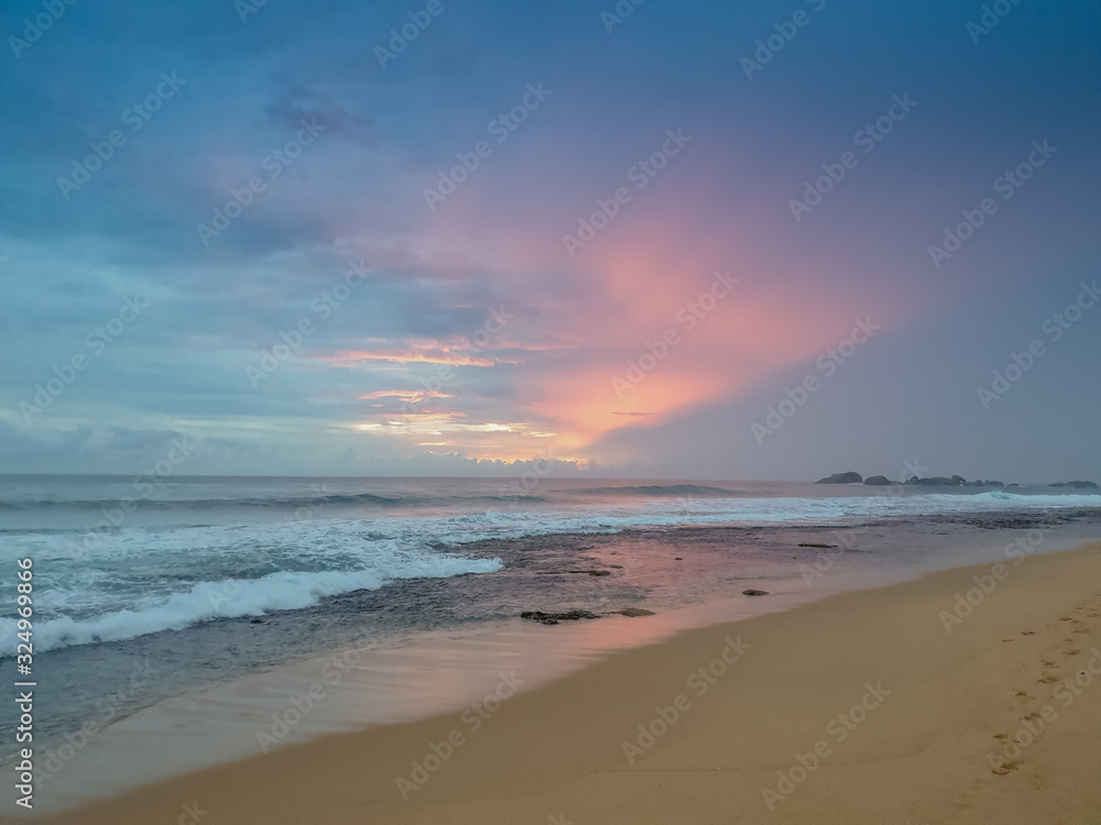 Toned image of beautiful colorful sky at sunset over the ocean