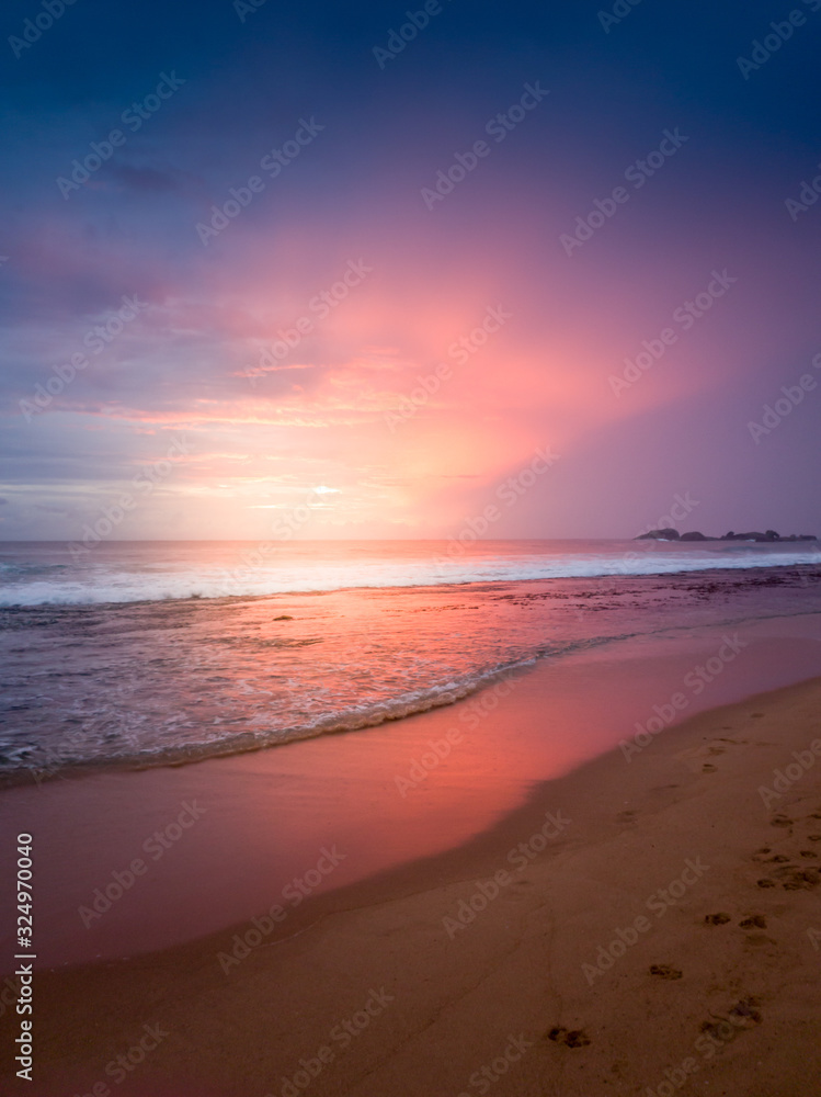 Amazing pink and purple sky at the sunset over the indian ocean on tropical island