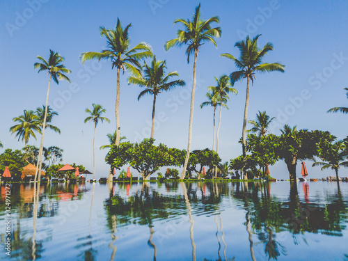 Toned image of beautiful infinity swimming pool o nhte tropical island