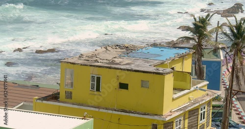 Close up detail angle establishing shot panning over colorful coastal homes in La Perla Puerto Rico