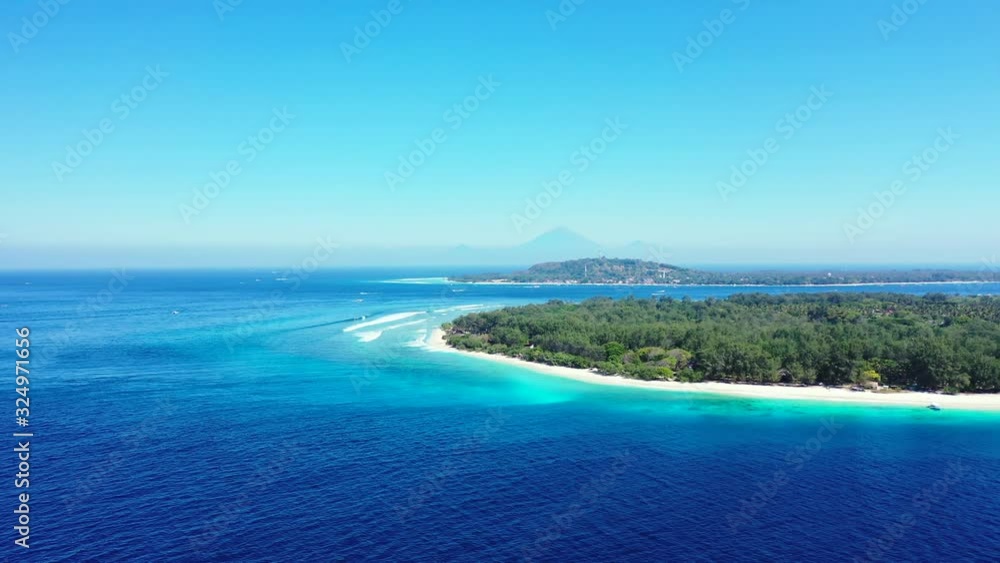 Vacations destination on tropical island with trees forest and white sandy beaches washed by blue azure sea water under clear bright sky in Gili, Indonesia Vacations destination on tropical island with trees forest and white sandy beaches washed by blue azure sea water under clear bright sky in Gili, Indonesia