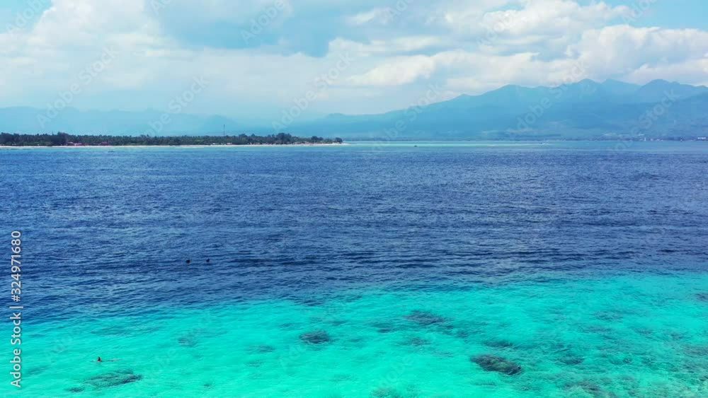 beautiful turquoise colors of the water on the cloudy day, Philipines. Mountains and small tropical island in the distance beautiful turquoise colors of the water on the cloudy day, Philipines. Mountains and small tropical island in the distance